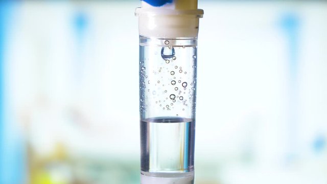 Dripping medical perfusion close up equipment in clinic background. Saline Solution IV Drip Fluid for Infusion in Hospital. Intravenous infusion tube equipment in hospital. Viral infection