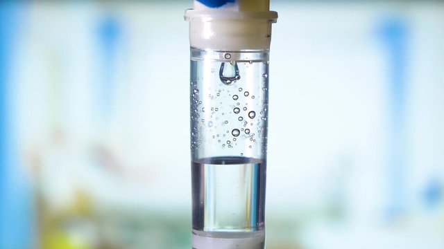 Dripping medical perfusion close up equipment in clinic background. Saline Solution IV Drip Fluid for Infusion in Hospital. Intravenous infusion tube equipment in hospital. Viral infection