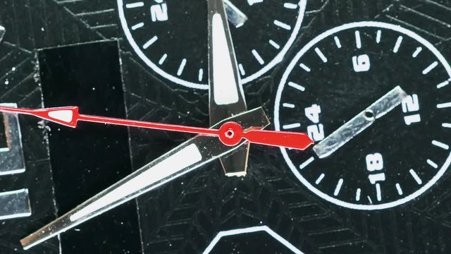 Macro shot of clock face with rapid rotation of all body and almost static seconds arrow. Fast flow of time concept. Real watch shot with wide macro lens close-up view. 4k.