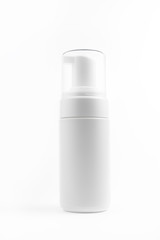 Photo of white plastic cosmetic bottle for foam over white background. Health and body care concept.