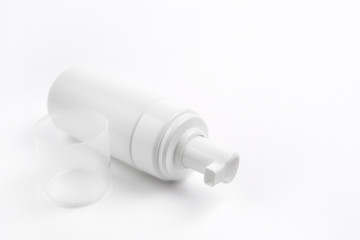 Photo of white plastic cosmetic bottle for foam over white background. Health and body care concept.