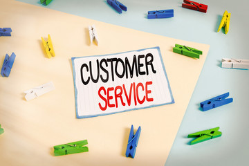 Conceptual hand writing showing Customer Service. Concept meaning process of ensuring client satisfaction with product Colored clothespin paper reminder with yellow blue background