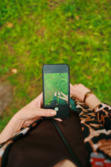 Woman in park. Top view Mobile photography concept