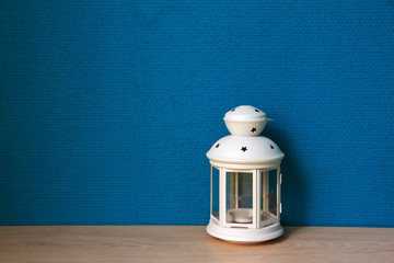 White lamp with blue wallpaper