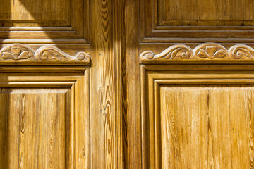 decorative pattern on surface of old wooden door, background with architectural elements