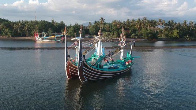 Close-up of large and beautiful Balinese boats on the background of the jungle and palm trees in Prancak Perancak west bali