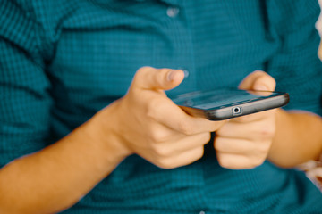 Close up of a man using mobile smartphone.