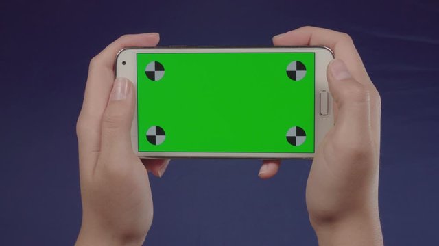 Woman using a smartphone with green screen &ndash; Chroma Key