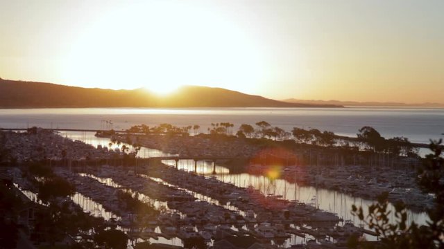 Bright Shining Sunrise over the hills and ocean harbor at dawn in Dana Point, California 