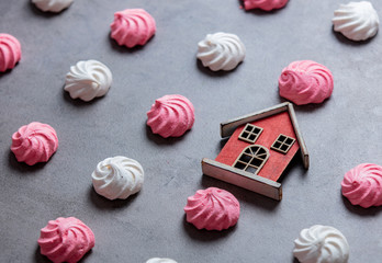 pink and white meringues with toy house