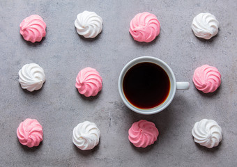 meringue and cup of coffee on gray