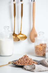 boiled buckwheat on a plate, vegetarian dish