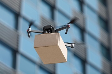 Smart modern drone carrying parcel in the city