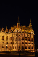 Fototapeta na wymiar Hungarian Parliament building in the city of Budapest. Budapest at night time. A sample of neo-gothic architecture, Budapest tourist attraction