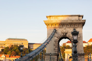 Obraz premium The Széchenyi Chain Bridge is the oldest bridge in Budapest, and the most famous. One of the two iconic lion statues are visible on the picture. There's a storm coming