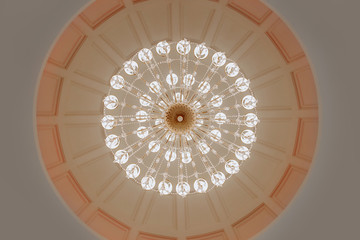 Close-up photo of vintage crystal chandelier in the restaurant.