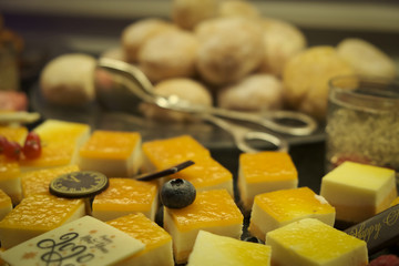 Close up of dessert buffet on new year 2020. Pieces of lemon cake. Petit four.