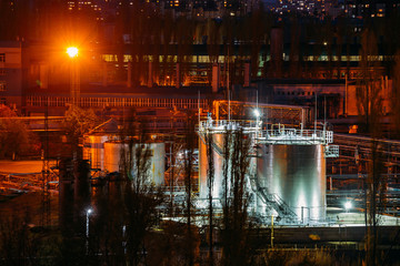 Storage tanks in chemical factory at night