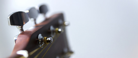 The upper part of the classical guitar, metal, shiny tunes, guitar detail.