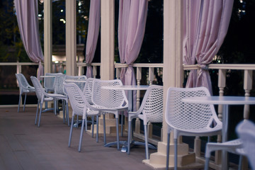 empty chairs and tables at restaurant veranda