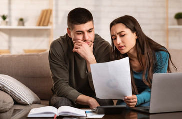 Young couple having financial problems, managing budget
