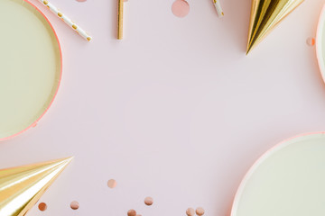 frame of birthday party supplies. dusty pink background
