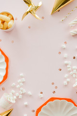 frame of birthday party supplies. dusty pink background