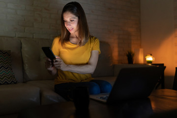Woman using technology at night
