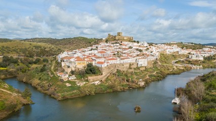 Fototapeta na wymiar Aerial view of the city of Mértola. Historic center of Mértola, castle, church, and Guadiana river, Alentejo, Portugal