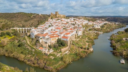 Fototapeta na wymiar Aerial view of the city of Mértola. Historic center of Mértola, castle, church, and Guadiana river, Alentejo, Portugal