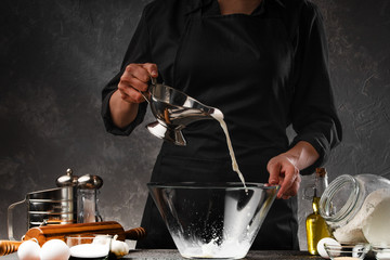 Professional chef cooks dough on milk. Freezing on the move. Cooking baking, dough. Cooking and recipe book, home baking, recipe book.