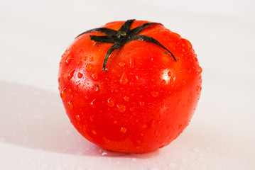 Fresh organic tomatoes with dew drops isolated on white background