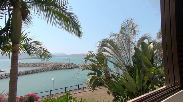 Summer Hotel Apartment Lounge, Balcony Terrace, Dining Area. Holiday Hotel room for use on vacation. Suite with couch seating to relax. Light and bright interior design. Whitsundays, Austraia.