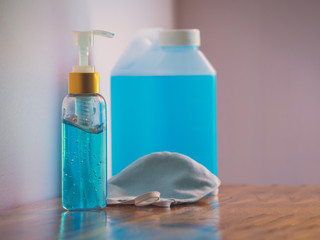 Hygienic face mask and Alcohol gel Sanitizer hand gel cleaners for anti Bacteria and virus on wooden table for hand hygiene corona virus or Covid-19. Pandemic protection, Hygienic concept