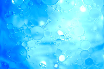 Blue glitter vintage lights background. Blue texture background. Oil drops in water.