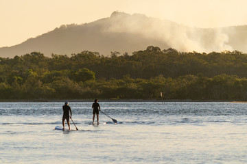 Against a beautiful late afternoon backdrop recreational water users riding Standup Paddleboards...