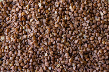 raw buckwheat, non-cooked buckwheat texture with grains of different colors in high quality