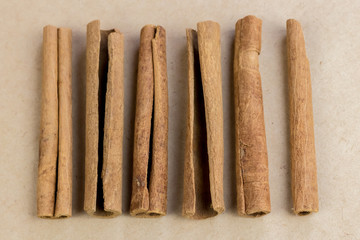 cinnamon sticks lie straight next to it vertically on a coarse linen cloth