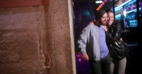 Multi-ethnic group of young friends leaving bar