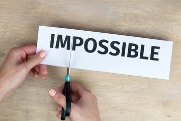 Woman cuts by scissors word 