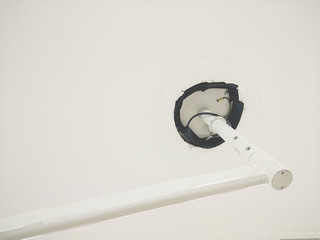 The base of the lamp is mounted to the ceiling.