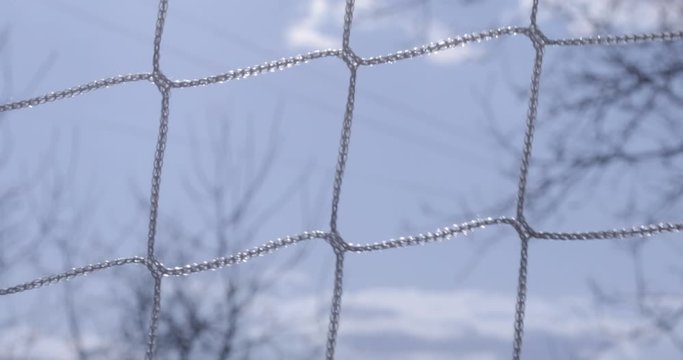 Soccer goal net close up sky out of focus in background