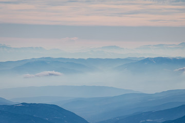Beautiful landscape of the Caucasus mountains in a foggy haze of clouds