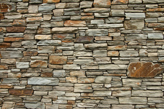 Natural background pattern, Otago schist stone wall, rugged grunge stone texture.