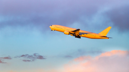 Fototapeta na wymiar 夕日を浴びながら羽田空港を離陸する飛行機