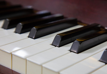 Close-up or macro image of piano keys by selective focus technique can be seen the details of classic instruments used in both Jazz and pop music which background and foreground are blurred.