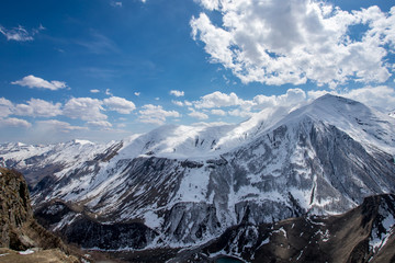 Beautiful panorama of the Caucasus mountains with clouds above them