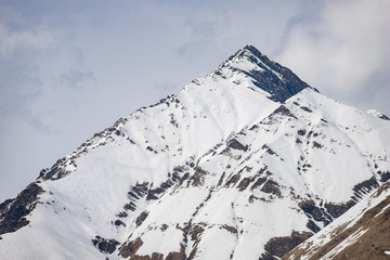 Mountain peak of the Caucasus mountains in cloudy weather