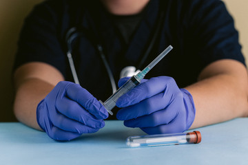 A medical professional with gloved hands holding a sterile syringe