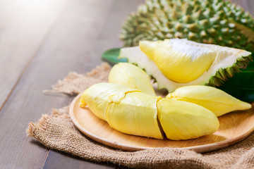 Fresh durian (monthong) on sack and old wood background,